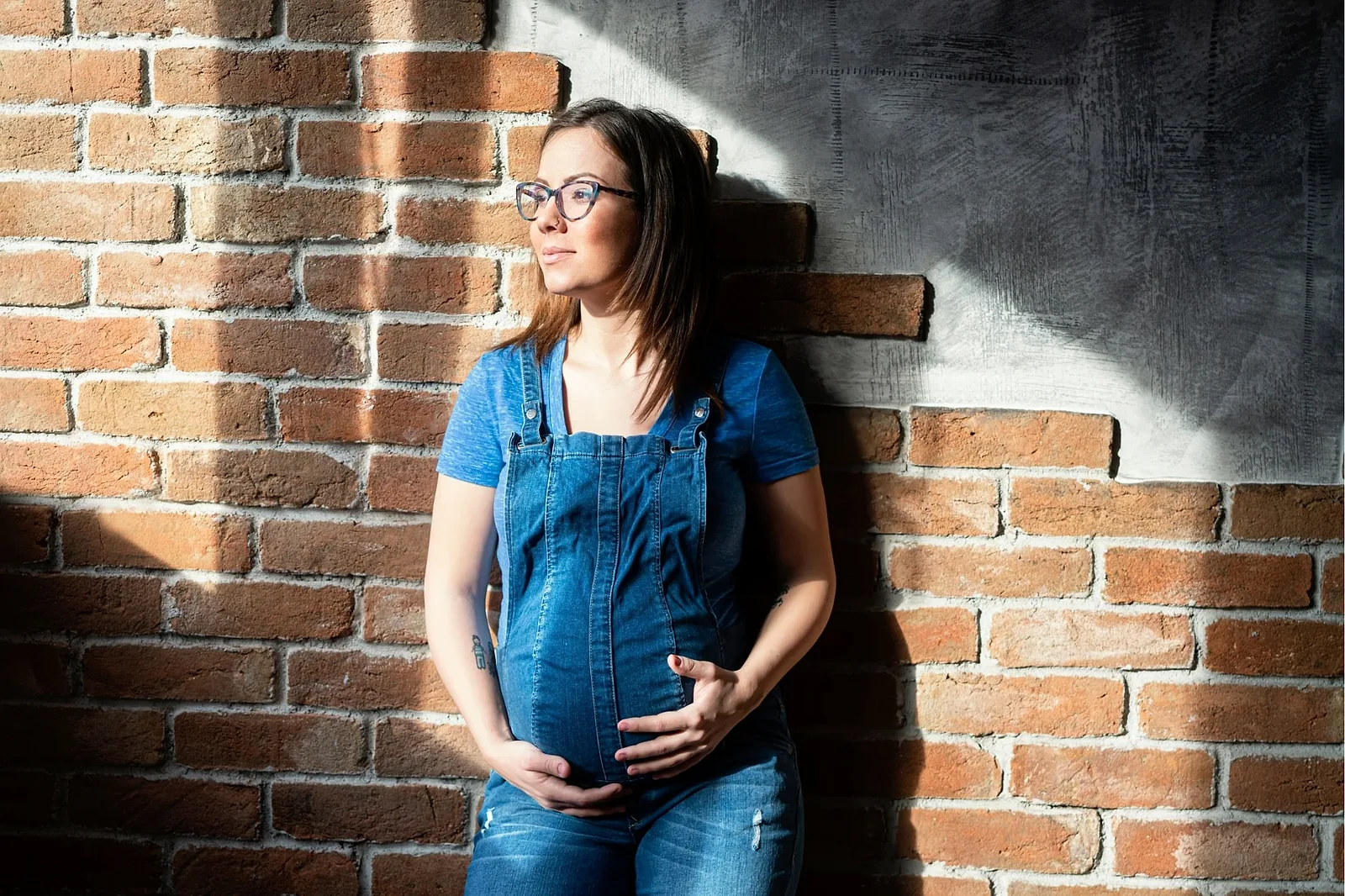 Pose with a Brick wall.
