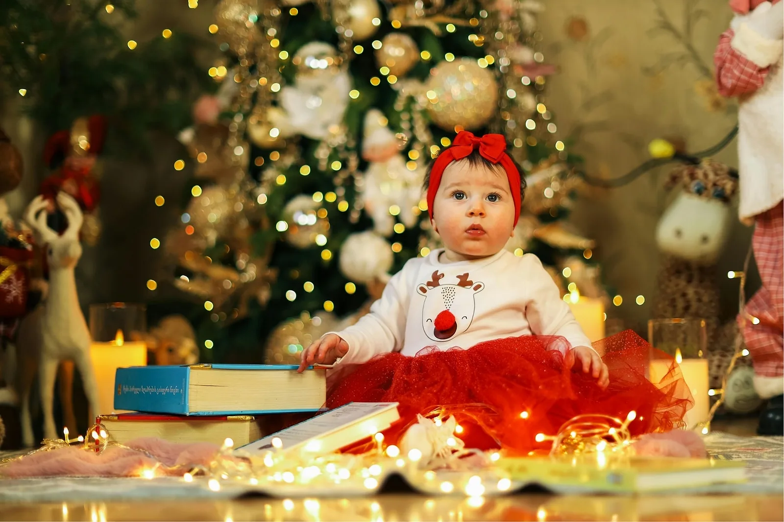 Baby Beside Their First Christmas Storybook.