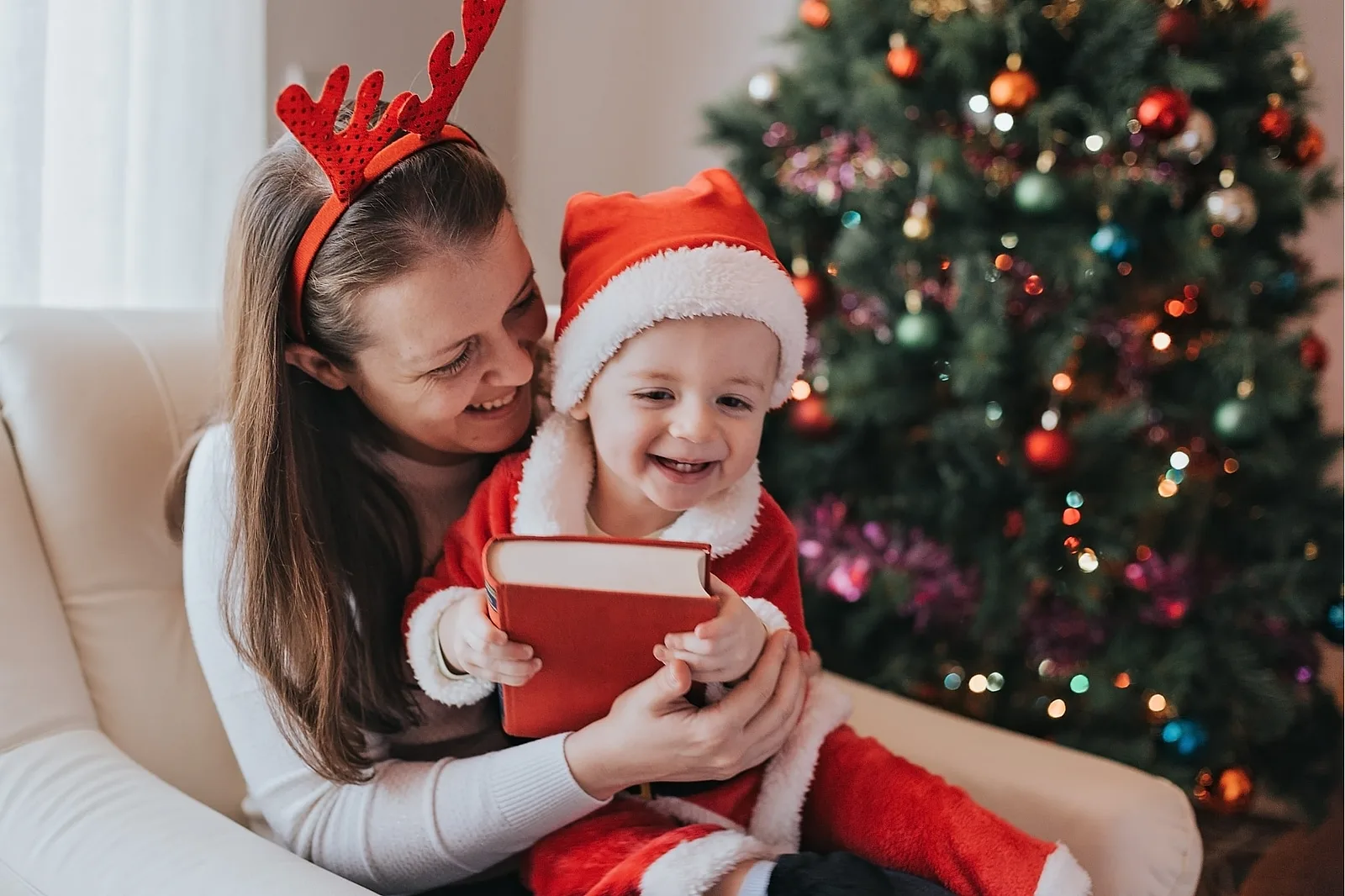 Parents Reading a Christmas Story to Baby.