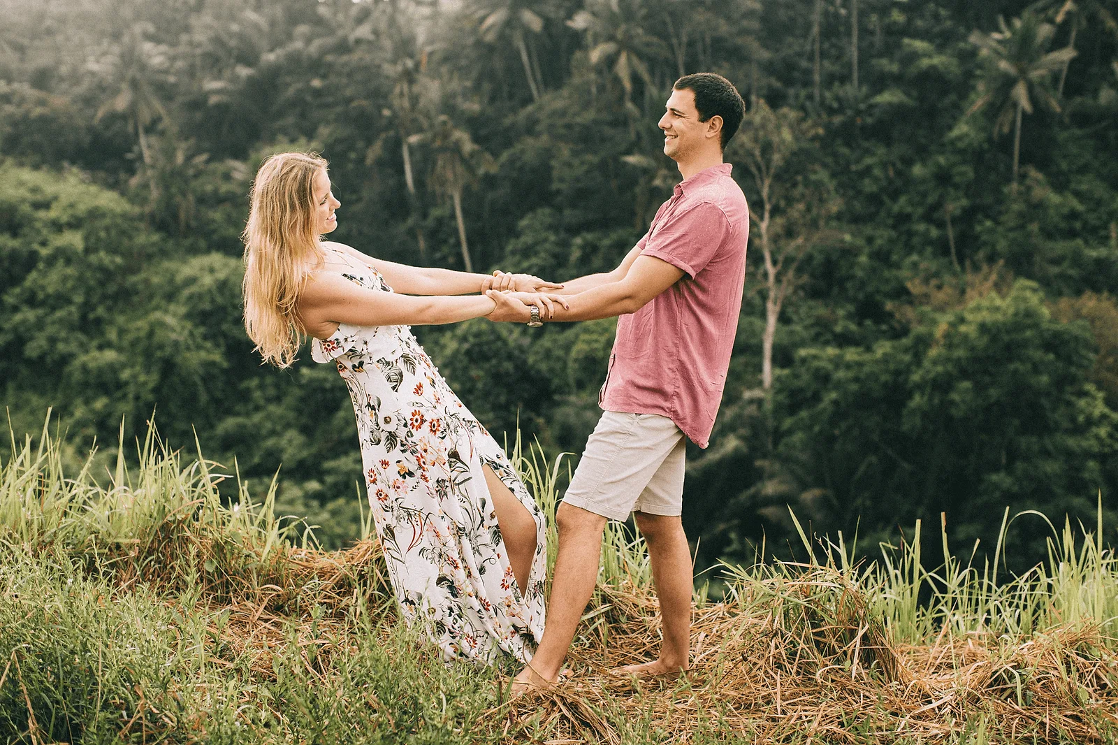 couple dancing in the rain in bali during a photoshoot