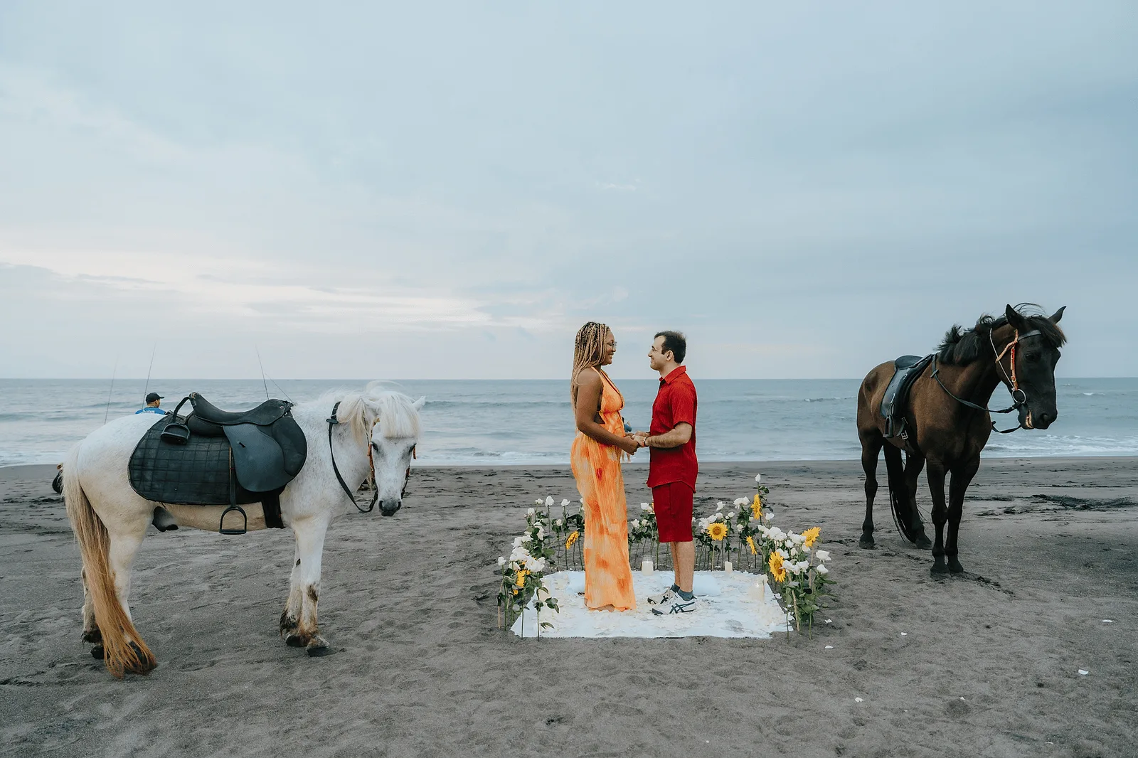 secret proposal on bali, man proposing to his girlfriend on the beach with horses