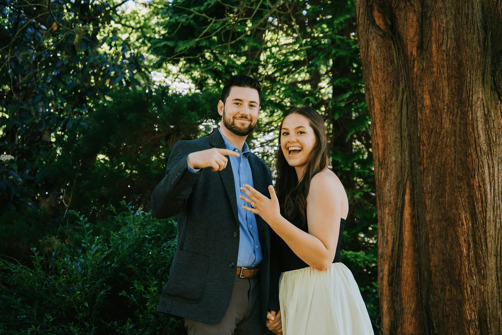 couple celebrating proposal during secret proposal photoshoot in edinburgh