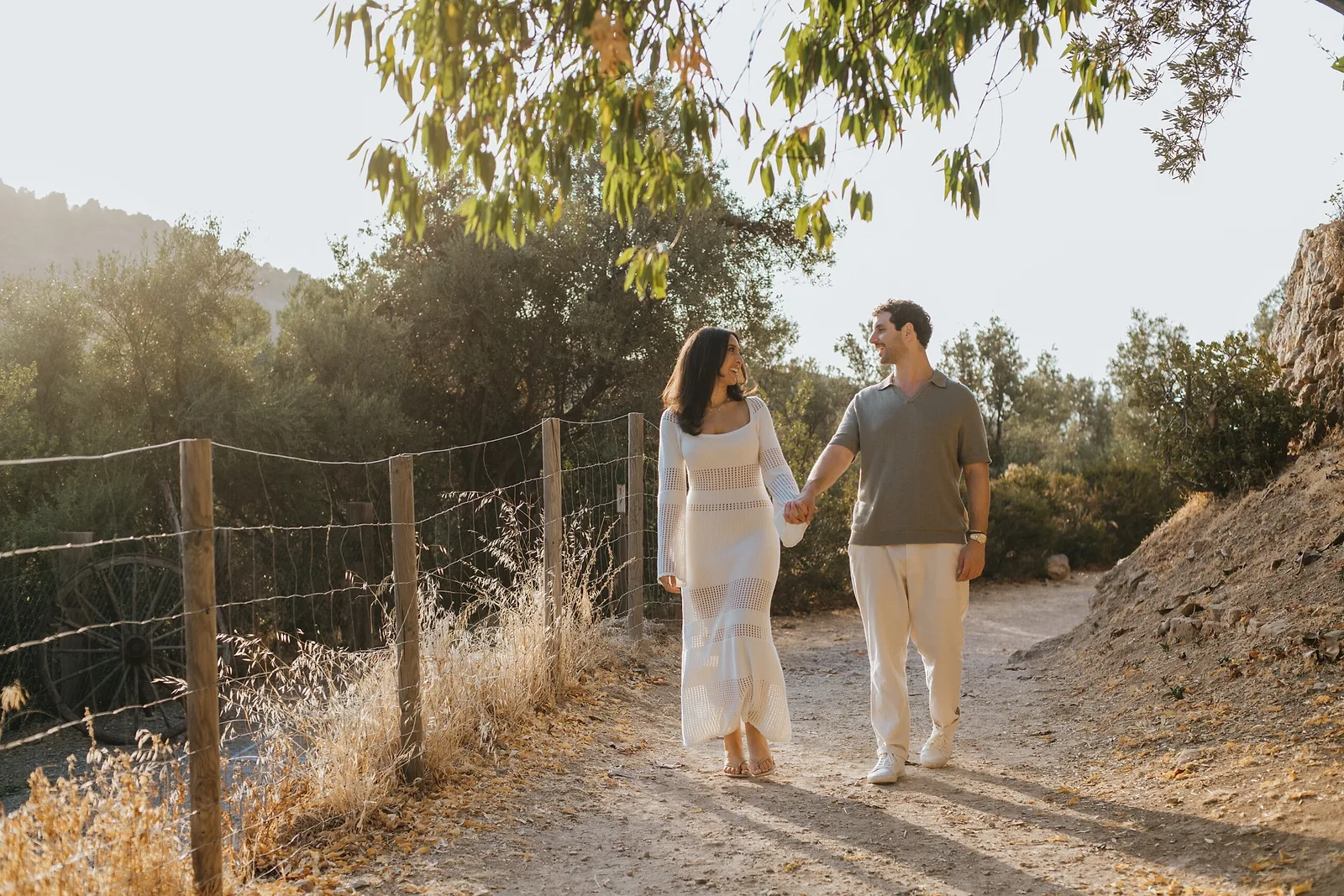 Couple walking hand in hand and smiling in Mallorca
