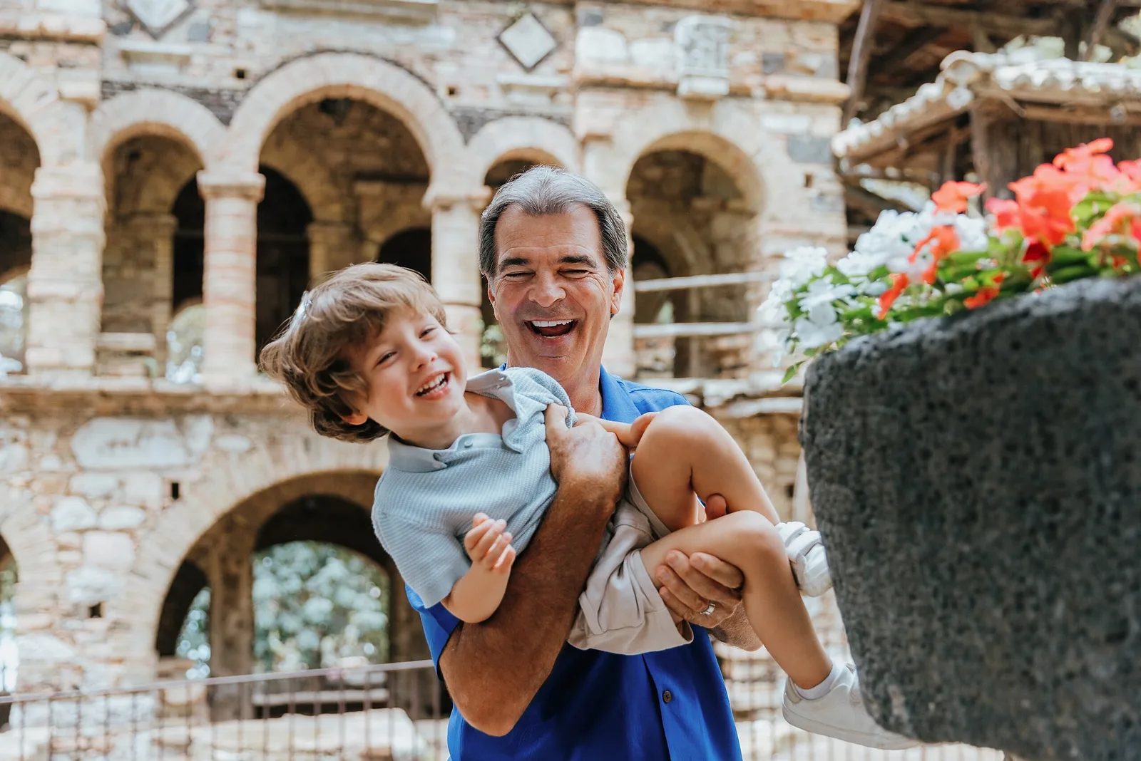 Father holding his son laughing in Taormina