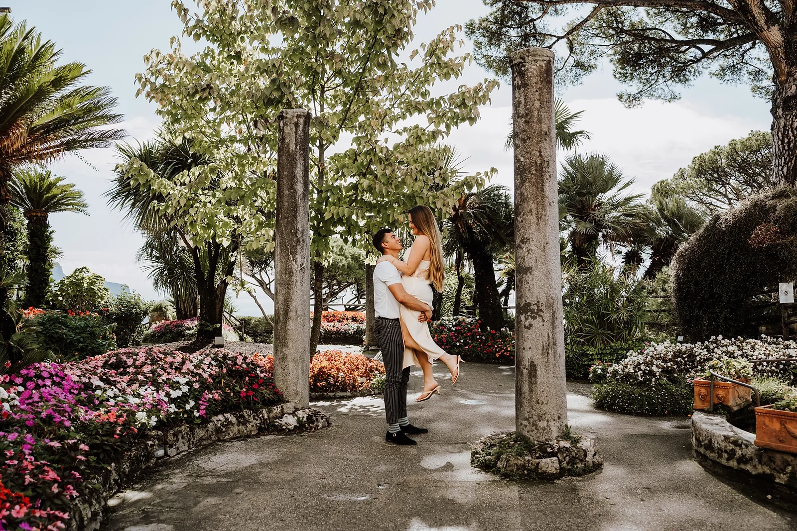 man lifting a happy woman at the Amalfi Coast