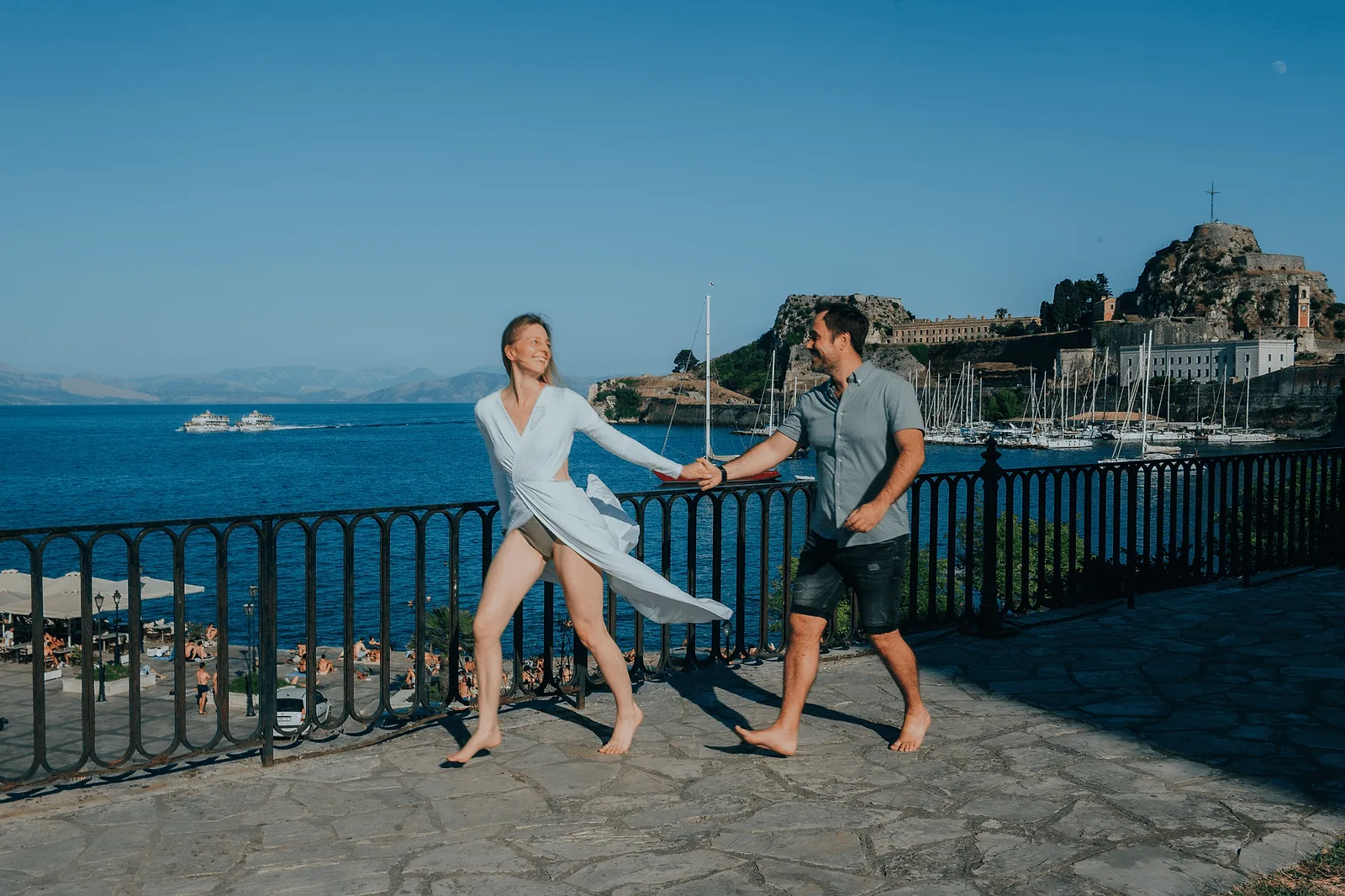 windy corfu couple posing for photographer