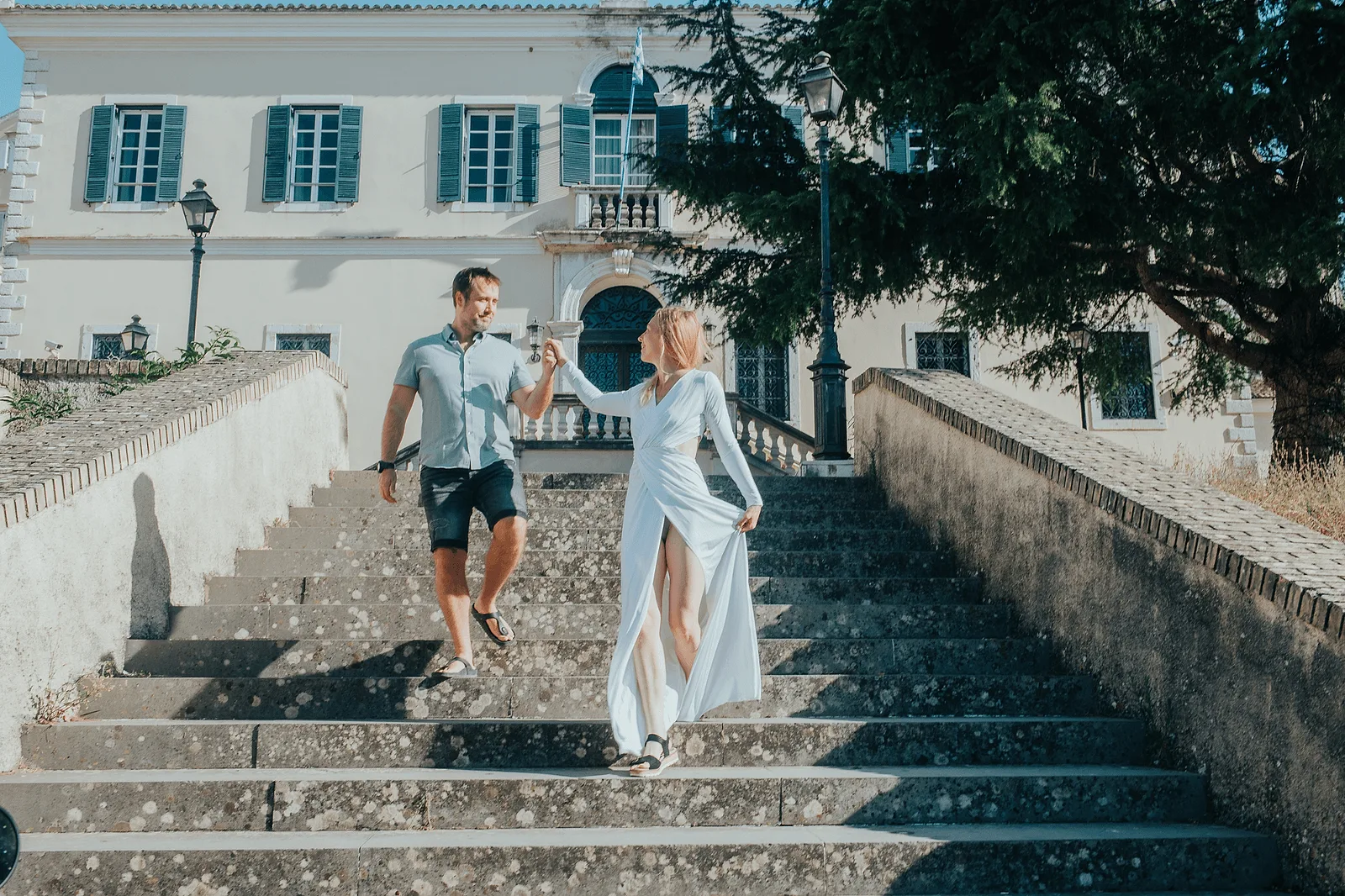 couple wlaking down the stairs in corfu