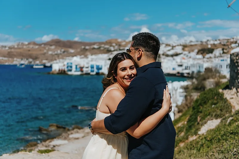 Happy woman smiling while hugging her man in Mykonos