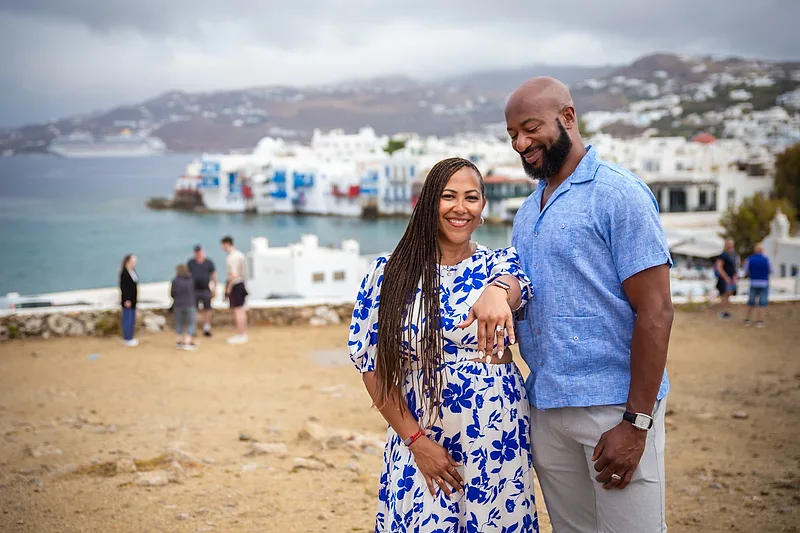 Woman showing of her engagement ring on a beach in Mykonos