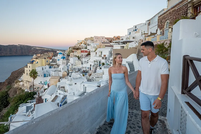 couple walking through santorini streets