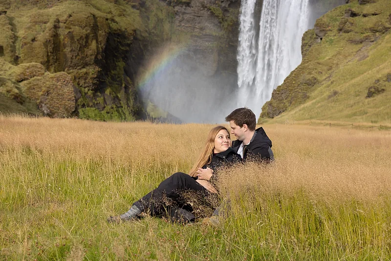 couple before proposal on iceland with a waterfall backdrop