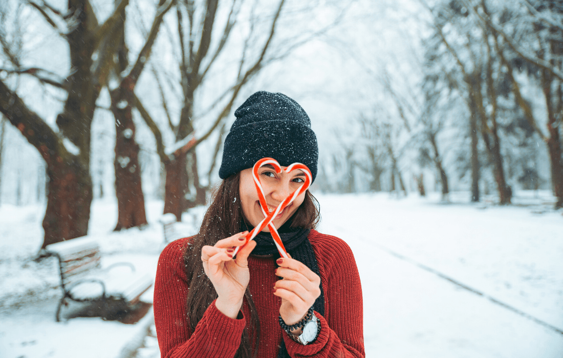 Premium Photo | A young, pretty girl poses under a large snow-covered pine  forest