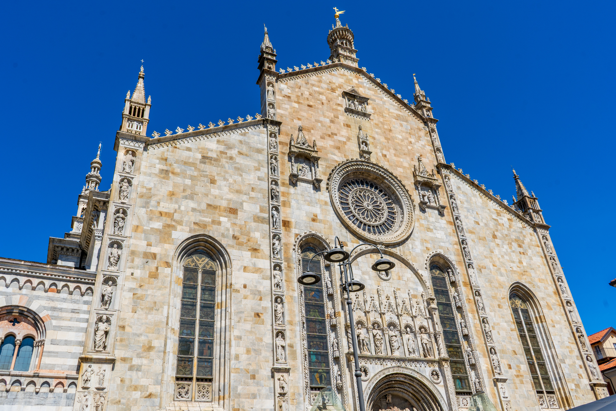 Como Cathedral Gothic-Renaissance facade of Como Cathedral on Piazza Duomo in early morning light, Lake Como