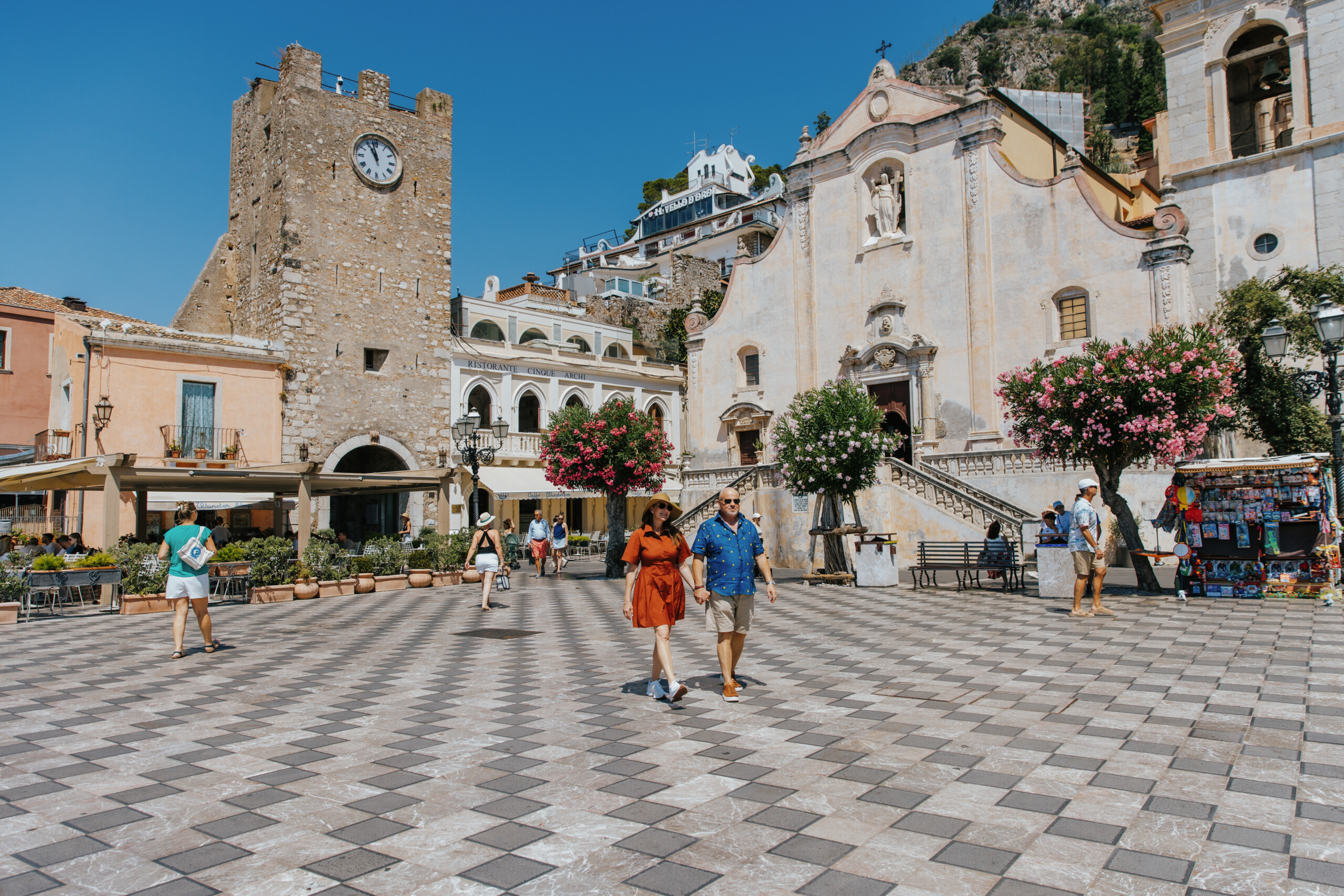 Pair of woman and man walking in Taormina, Sicily