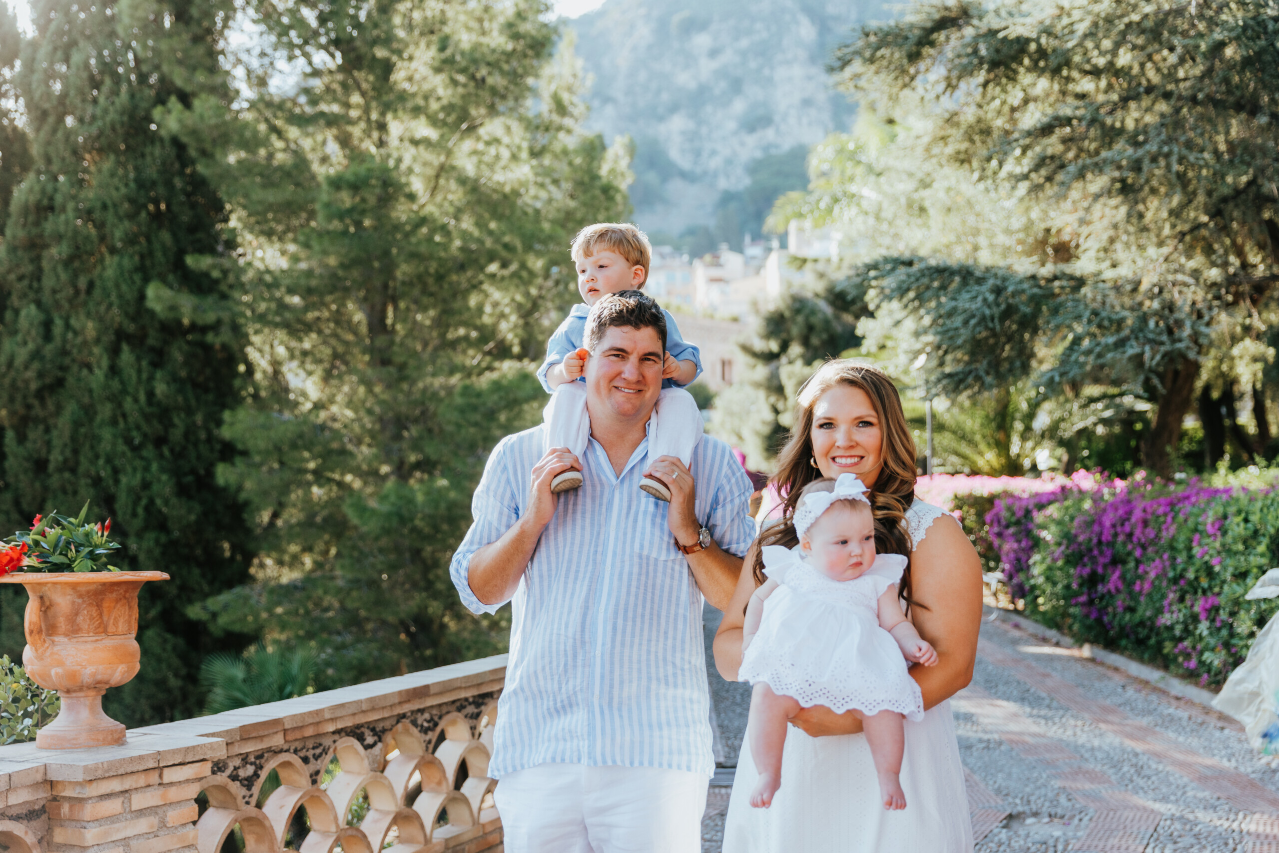 Family walking through garden in Taormina