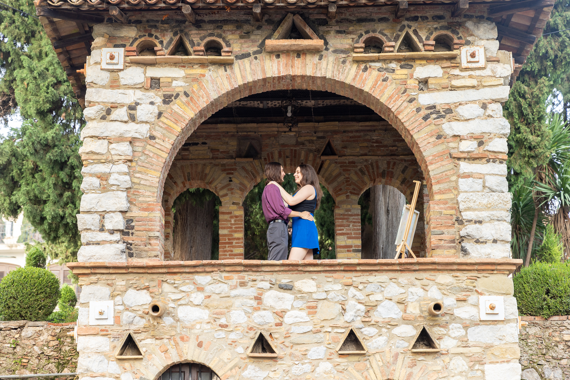Couple embracing each other in a window in Taormina