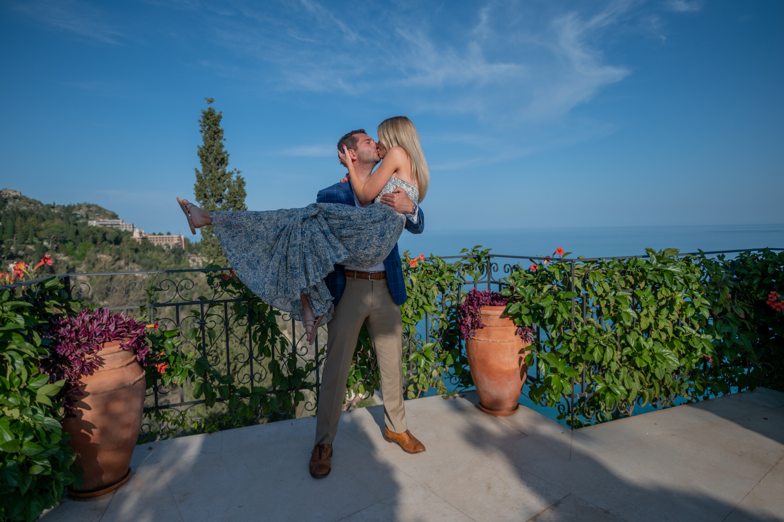 Man lifting woman in his arms in Taormina