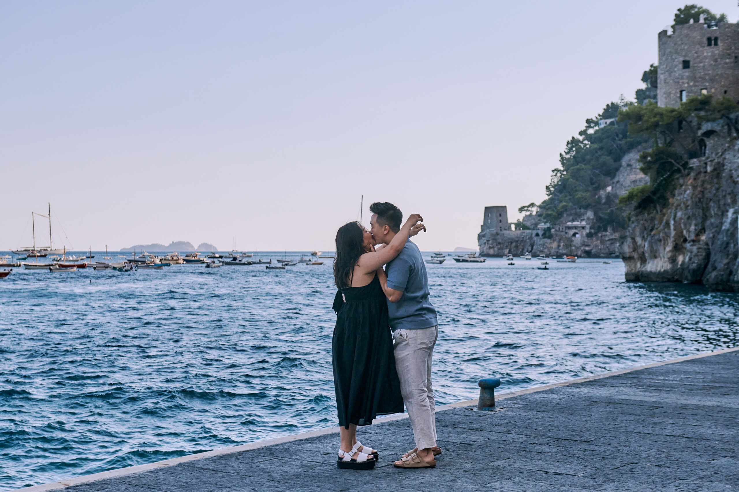 woman hugging a man by the sea