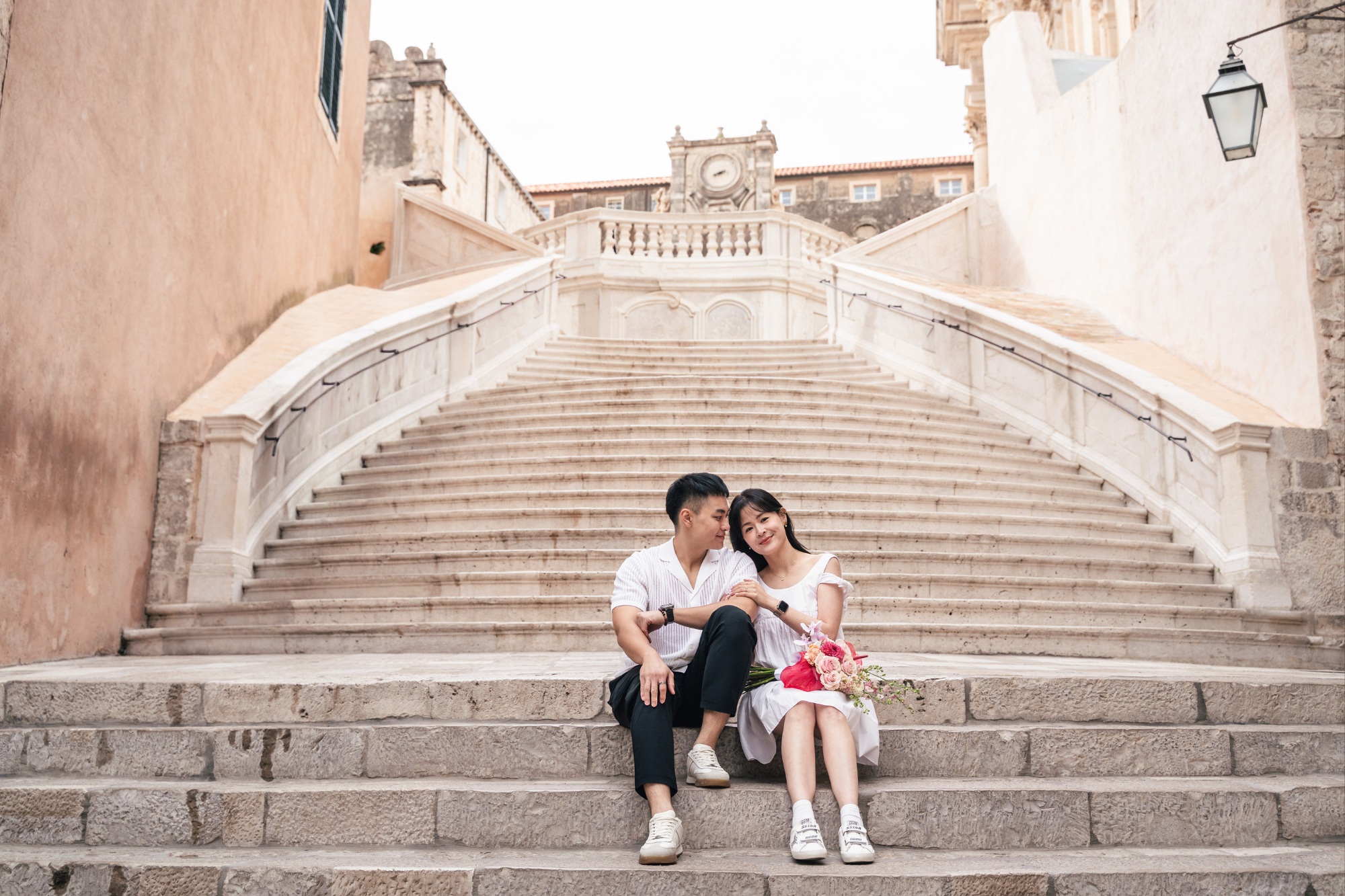 couple sitting on stairs in dubrovnik city centre