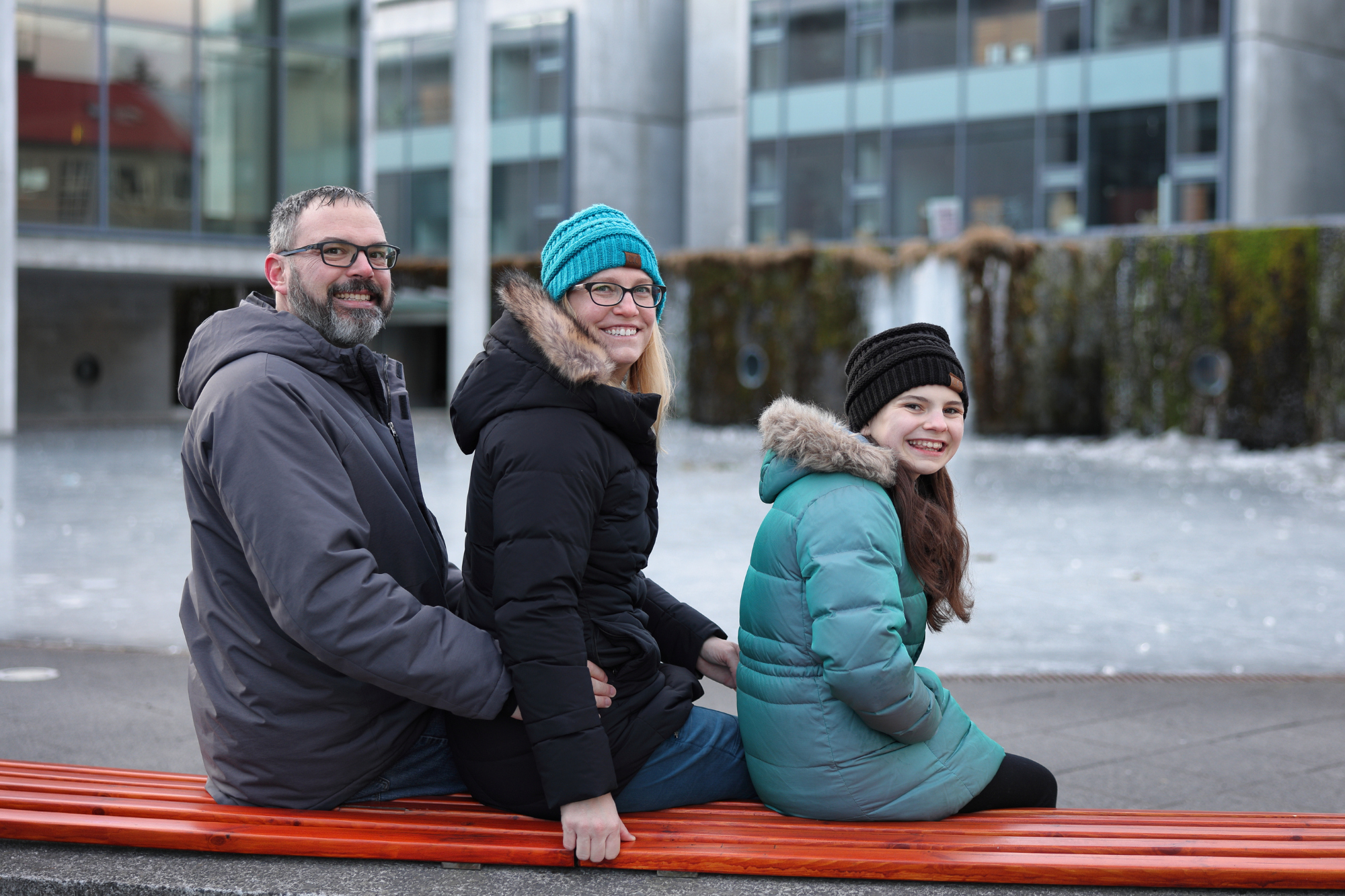 family posing while sitting on a bench in reykjavik iceland